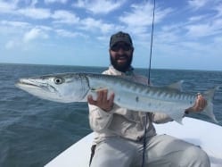 Nathaniel holds his personal best barracuda on fly: a over-50-inch monster. Guiding/photo courtesy Captain Doug Kilpatrick