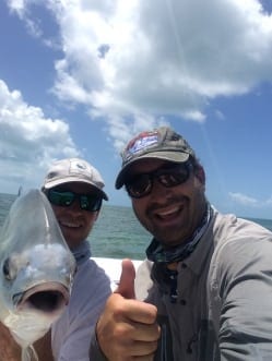 Nathaniel and Zack hold their permit from July. Selfie courtesy Nathaniel Linville, guiding Captain Zack Stells