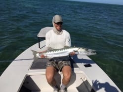 Ian hoists one of the three wolfs from the second day of fishing in December. Photo: Nathaniel Linville, guiding Ian Slater