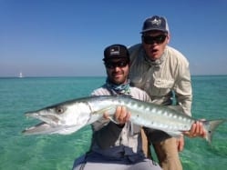 Nathaniel holds a giant, coaxed from the white sand. Michael Hetzel looks on, mean mugging for guide/photographer John O'Hearn