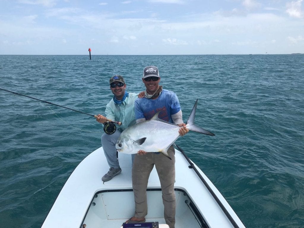 Nate and Ian with a large permit, hooked from a nearby mud in the clouds. Photo Kat Vallilee, guiding Ian Slater